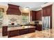 Elegant kitchen featuring custom cabinets, a large island, stainless steel appliances, and granite countertops at 922 Jasmine St, Celebration, FL 34747