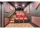Cozy home theater with tiered seating, a projector, and soundproofing panels at 922 Jasmine St, Celebration, FL 34747