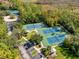 Overhead view of multiple community tennis courts surrounded by lush trees at 922 Jasmine St, Celebration, FL 34747