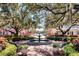 Charming town center scene with a tiered fountain, benches, and mature trees at 922 Jasmine St, Celebration, FL 34747