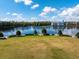 Scenic water view of a calm lake and bright blue sky with white clouds, with grassy area and trees in the foreground at 922 Jasmine St, Celebration, FL 34747