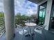 Relaxing balcony featuring sleek metal chairs and table with a view of trees and the sky at 10 N Summerlin Ave # 14, Orlando, FL 32801