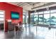 Modern dining area with glass table, stylish chairs, and large windows offering natural light and neighborhood views at 10 N Summerlin Ave # 14, Orlando, FL 32801