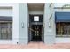 The building's entrance featuring modern design elements, decorative lighting, and a secured doorway at 10 N Summerlin Ave # 14, Orlando, FL 32801