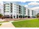 Multi-story condominium building featuring an attractive color scheme, well-maintained landscaping, and convenient commercial space at 10 N Summerlin Ave # 14, Orlando, FL 32801