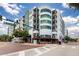 Multi-story condominium with balconies in a urban area with blue sky, convenient parking and commercial space at 10 N Summerlin Ave # 14, Orlando, FL 32801
