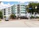 Condominium building with balconies in urban area, lush landscaping and commercial space for easy access to amenities at 10 N Summerlin Ave # 14, Orlando, FL 32801