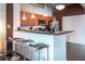 Modern kitchen with a breakfast bar, stainless steel appliances, pendant lighting, and dark countertops at 10 N Summerlin Ave # 14, Orlando, FL 32801