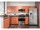 Modern kitchen with stainless steel appliances, stylish cabinets, dark countertops and black tiled floor at 10 N Summerlin Ave # 14, Orlando, FL 32801