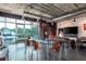 Bright living room with modern furnishings, an industrial ceiling, and expansive windows with neighborhood views at 10 N Summerlin Ave # 14, Orlando, FL 32801