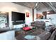 Open-concept living room featuring modern decor, an industrial ceiling, and comfortable seating near the kitchen bar at 10 N Summerlin Ave # 14, Orlando, FL 32801