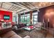 Spacious living room featuring modern furniture, industrial-style ceiling, and expansive windows with bright natural light at 10 N Summerlin Ave # 14, Orlando, FL 32801