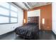 Modern main bedroom features a plush bed, dark accents, contemporary lamps, and an industrial-style ceiling at 10 N Summerlin Ave # 14, Orlando, FL 32801
