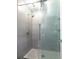Modern shower with glass door and gray tiled walls at 10 N Summerlin Ave # 14, Orlando, FL 32801