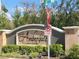 Elegant community sign with the name 'Ambergate' surrounded by lush greenery and neighborhood signage at 1003 E 10 St, Apopka, FL 32703