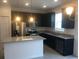 Spacious kitchen featuring granite countertops, stainless steel appliances, a center island, and dark wood cabinets at 1003 E 10 St, Apopka, FL 32703