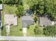 Aerial view of the property, showcasing the home, surrounding greenery, and pool at 1181 Pine Ln, St Cloud, FL 34771