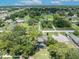 Expansive aerial view of property within the community, surrounded by mature trees at 1181 Pine Ln, St Cloud, FL 34771
