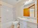 The bathroom showcases a tub and shower combination, a sink, and a window at 1181 Pine Ln, St Cloud, FL 34771