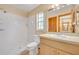 The bathroom is equipped with a shower, a sink, and a window for natural light and ventilation at 1181 Pine Ln, St Cloud, FL 34771