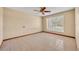 The bedroom features neutral walls, tile floor, a ceiling fan, and a window for natural light at 1181 Pine Ln, St Cloud, FL 34771