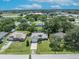 Picturesque suburban home with lush greenery, manicured lawns, and mature trees around the property at 1181 Pine Ln, St Cloud, FL 34771