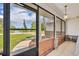Inviting screened front porch offers a serene view of the neighborhood at 1181 Pine Ln, St Cloud, FL 34771