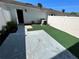 Private backyard with a concrete patio and artificial turf, perfect for outdoor relaxation at 12359 Langstaff Dr, Windermere, FL 34786