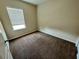 Neutral bedroom featuring neutral walls, brown carpeting, and a window for ample natural light at 12359 Langstaff Dr, Windermere, FL 34786