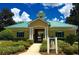 Community clubhouse featuring a yellow exterior, green shutters and a gated entrance at 12359 Langstaff Dr, Windermere, FL 34786