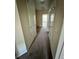 Hallway featuring neutral walls, brown carpeting, multiple closets and access to several rooms at 12359 Langstaff Dr, Windermere, FL 34786
