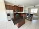 Modern kitchen with stainless steel appliances, granite countertops, and a center island at 12359 Langstaff Dr, Windermere, FL 34786
