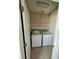 Convenient laundry room with a washer and dryer, plus shelving at 12359 Langstaff Dr, Windermere, FL 34786