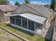 Aerial view of the home's backyard with screened-in lanai and landscaping at 12938 Maribou Cir, Orlando, FL 32828