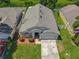 Aerial view of the property showcasing its well-maintained exterior, roof, and surrounding landscape at 12938 Maribou Cir, Orlando, FL 32828