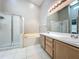 Bathroom featuring double vanity, shower with glass door, and a soaking tub at 12938 Maribou Cir, Orlando, FL 32828