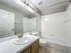 Bright bathroom with a large mirror, vanity, shower, and tub at 12938 Maribou Cir, Orlando, FL 32828