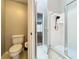 Clean and functional bathroom featuring toilet and glass-enclosed shower at 12938 Maribou Cir, Orlando, FL 32828