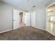 Spacious carpeted bedroom featuring a double door closet and ample natural light at 12938 Maribou Cir, Orlando, FL 32828