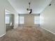 Open bedroom with neutral colors, ceiling fan and two windows for natural light at 12938 Maribou Cir, Orlando, FL 32828