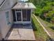 Exterior side yard with screened lanai, patio, and tropical landscaping at 12938 Maribou Cir, Orlando, FL 32828