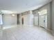 Bright foyer featuring tile flooring, high ceilings, and ample natural light from the front door windows at 12938 Maribou Cir, Orlando, FL 32828