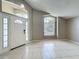Bright foyer featuring tile flooring, high ceilings, and ample natural light from the front door windows at 12938 Maribou Cir, Orlando, FL 32828