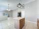 Open kitchen features an island, tile flooring, and stainless steel appliances at 12938 Maribou Cir, Orlando, FL 32828