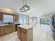 Open kitchen features an island, tile flooring, and stainless steel appliances at 12938 Maribou Cir, Orlando, FL 32828