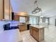 Open kitchen features an island, tile flooring, and stainless steel appliances at 12938 Maribou Cir, Orlando, FL 32828