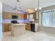 Bright kitchen features an island, tile flooring, and stainless steel appliances at 12938 Maribou Cir, Orlando, FL 32828