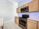 Kitchen features stainless steel appliances and light wood cabinets at 12938 Maribou Cir, Orlando, FL 32828
