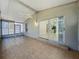 Enclosed tiled lanai with fan and sliding glass doors into the home at 12938 Maribou Cir, Orlando, FL 32828