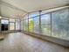 Enclosed tiled lanai with fan and screens offering exterior views at 12938 Maribou Cir, Orlando, FL 32828